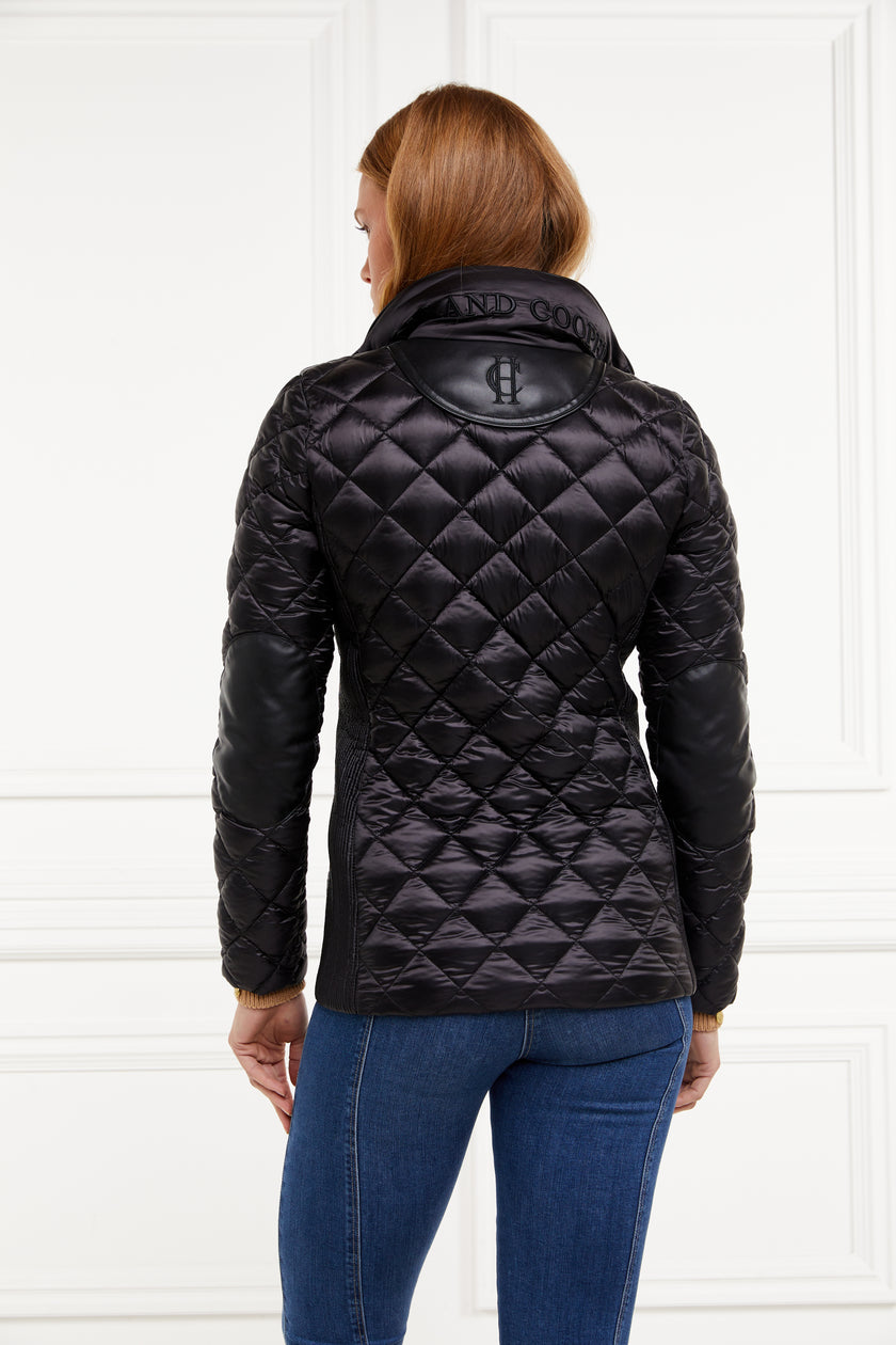 back of womens diamond quilted black jacket with contrast black leather elbow and shoulder pads large front pockets and shirred side panels