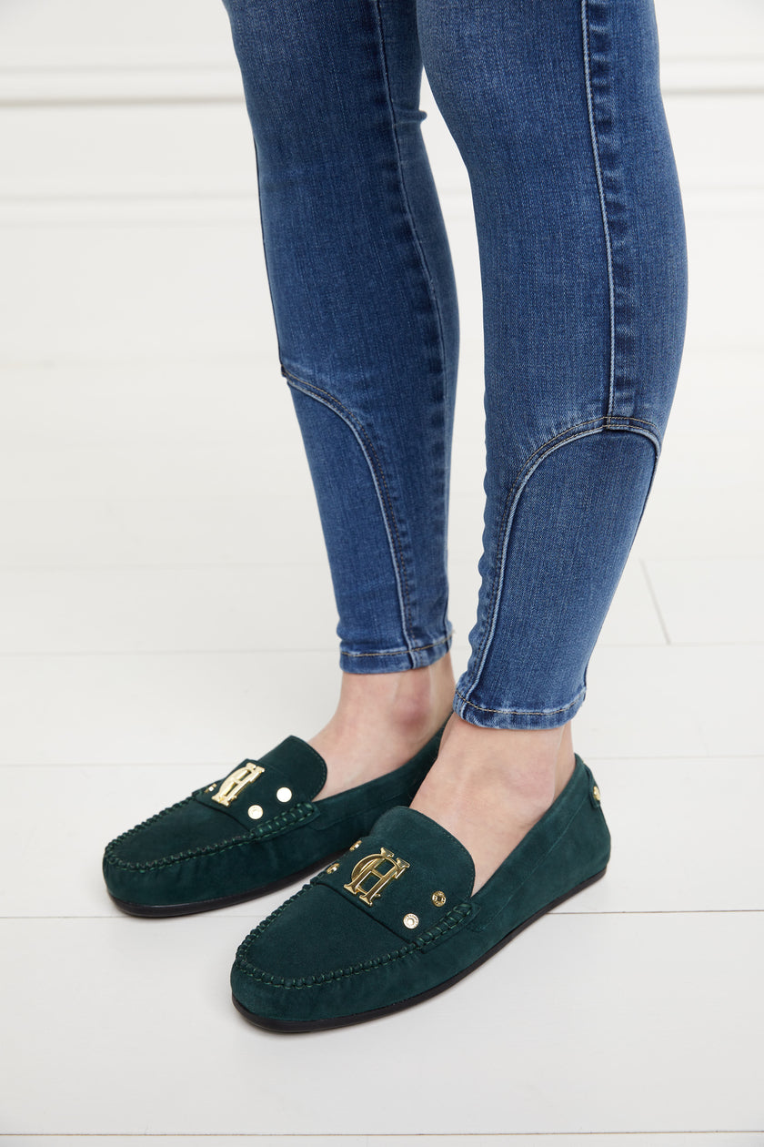 classic emerald green suede loafers with a leather sole and top stitching details and gold hardware paired with a classic denim skinny jean