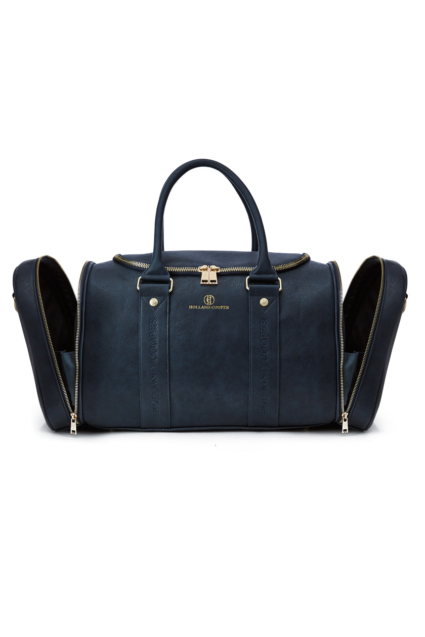 details shot showing open left and right side compartments on navy faux leather equestrian kit bag