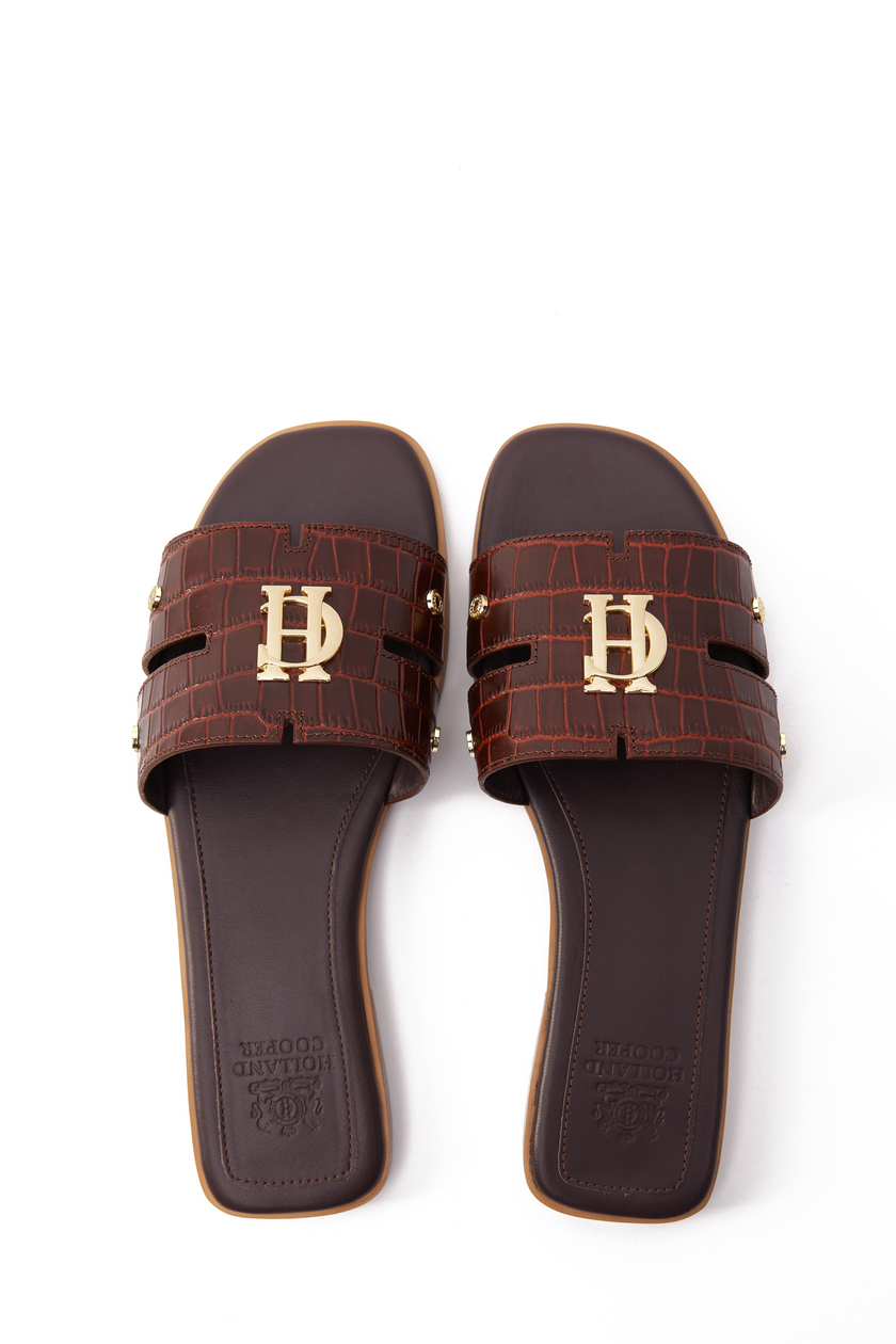 Birds eye view of brown croc embossed leather sliders with a tan leather sole and gold hardware
